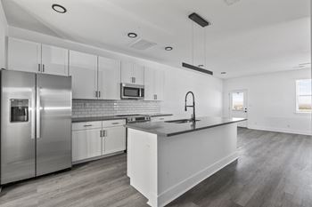 Open concept kitchen with island or bar
